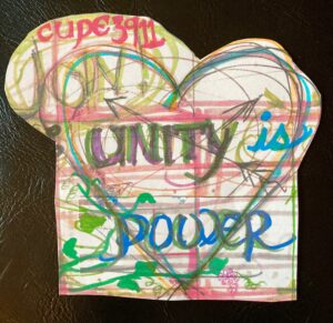A hand-drawn, multi-coloured heart shape, with the words "Join CUPE 3911" and "Unity is Power" written inside and around it.